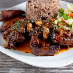 Reggae's Jamaican Grill - Oxtail Meal. Meal will be served in a To-Go container.