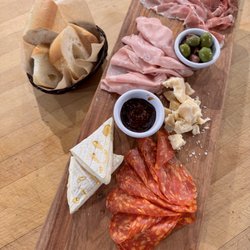 Charcuterie with imported meats, imported cheese, fig jam, olives and fresh bread