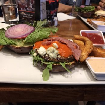 Grumpy Goat Tavern - Bleu Goat & Duck Burger on a pretzel bun with Cajun fries - Cajun/Creole Near Me - Elgin, Illinois