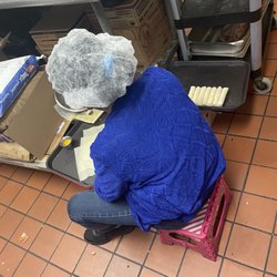 Pho Big Bowl - One of the workers making fried rolls on the floor