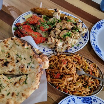 Karimi Restaurant - Man! What a spread! Garlic naans, tandoori boti (quarter), malai botis and chicken hakka noodles. - Indian Near Me - San Jose, California Karimi Restaurant - Man! What a spread! Garlic naans, tandoori boti (quarter), malai botis and chicken hakka noodles. - Indian Near Me - San Jose, California