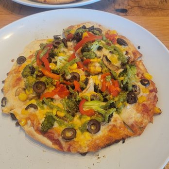 MOD Pizza - Mini with regular sauce and mozzarella, broccoli, mushrooms, roasted peppers, corn, black olives, and pesto. - Fast Food Near Me - Richmond, Texas MOD Pizza - Mini with regular sauce and mozzarella, broccoli, mushrooms, roasted peppers, corn, black olives, and pesto. - Fast Food Near Me - Richmond, Texas