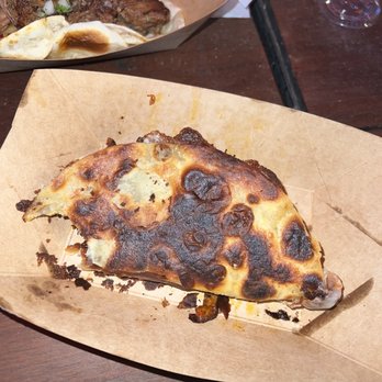 Asador - a slice of pizza on a table - Tacos Near Me - Austin, Texas Asador - a slice of pizza on a table - Tacos Near Me - Austin, Texas