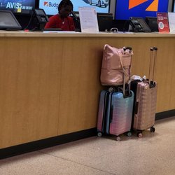 Avis Car Rental - Customer Service rep allows a customer to go outside to use her cell phone for 20 minutes and does NOT help the next person in line