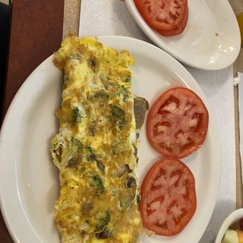 The Waffle Shop Downtown - Omelette with broccoli sausage mushrooms cheddar cheese and sliced tomatoes. - Breakfast & Brunch Near Me - State College, Pennsylvania The Waffle Shop Downtown - Omelette with broccoli sausage mushrooms cheddar cheese and sliced tomatoes. - Breakfast & Brunch Near Me - State College, Pennsylvania
