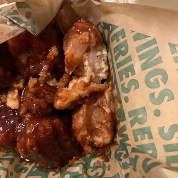 Wingstop - a close up of a bag of food - Chicken Wings Near Me - Tupelo, Mississippi
