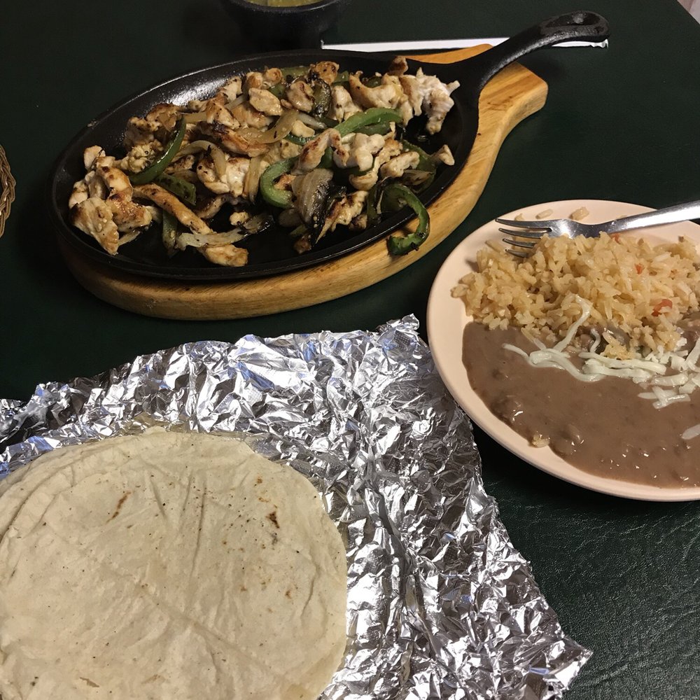 a plate of chicken, rice, and a tortilla a plate of chicken, rice, and a tortilla