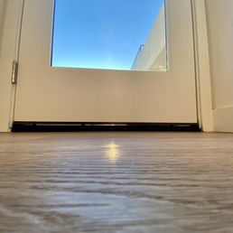 Door installed with gap at bottom which causes wind/water intrusions Door installed with gap at bottom which causes wind/water intrusions
