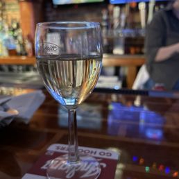 a glass of wine on a bar a glass of wine on a bar