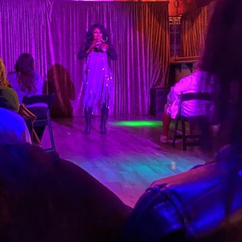 IBT's - a woman in a purple dress on stage - Gay Bars Near Me - Tucson, Arizona IBT's - a woman in a purple dress on stage - Gay Bars Near Me - Tucson, Arizona