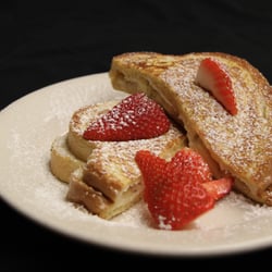 McCormick Cafe - Oxford French Toast - filled with bananas and signature heavenly spread. battered, grilled, and topped with fresh strawberries