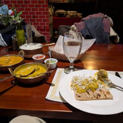 Clove Garden of India - Whole wheat naan on the right, and spinach korma along with vegetables in an orange sauce.