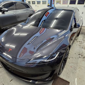 Mirror Image Detailing - 50% window tints on the front windshield, plus custom red Tesla decal on the emblem. - Auto Detailing Near Me