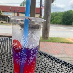 a drink in a plastic cup with a blue straw a drink in a plastic cup with a blue straw