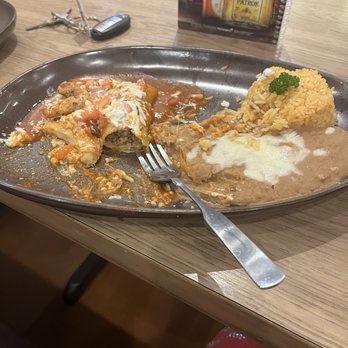 Bravos Mexican Grill - cheese and beef enchilada lunch (half eaten) with rice and beans. - Mexican Near Me - Tulsa, Oklahoma Bravos Mexican Grill - cheese and beef enchilada lunch (half eaten) with rice and beans. - Mexican Near Me - Tulsa, Oklahoma