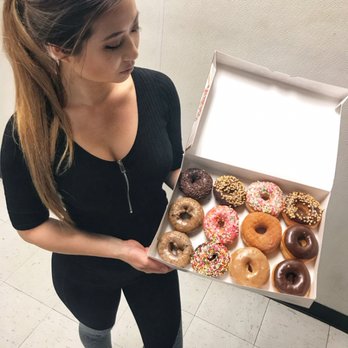 USA Donuts - a woman holding a box of doughnuts - Donuts Near Me - Palestine, Texas USA Donuts - a woman holding a box of doughnuts - Donuts Near Me - Palestine, Texas