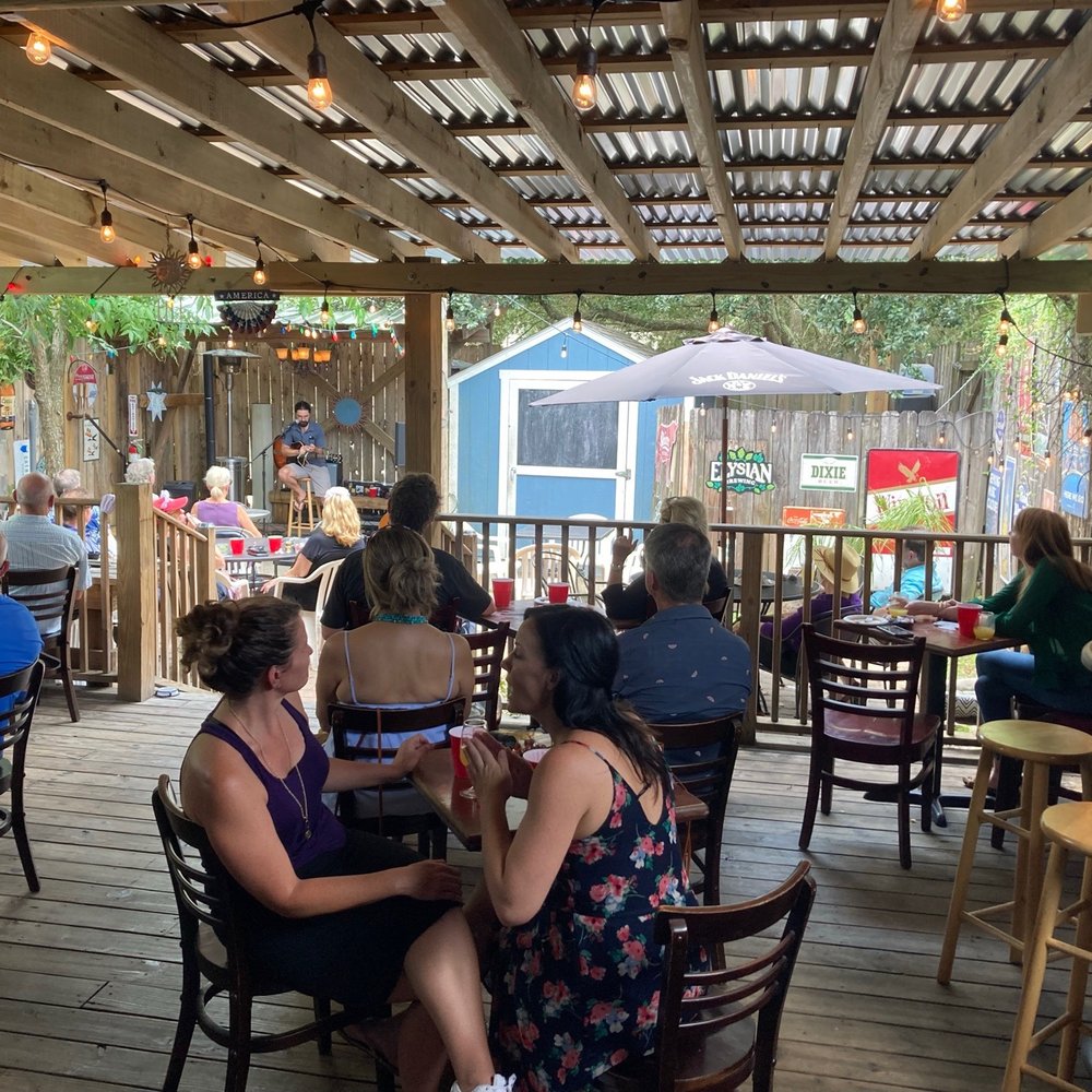 Carrollton Station - a group of people sitting at tables - Bars Near Me - New Orleans, Louisiana