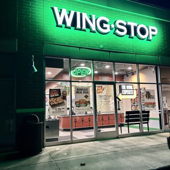 Wingstop - the front of a restaurant at night - Chicken Wings Near Me - Monroe, Michigan