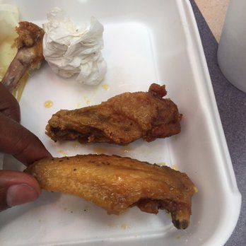 Wings & Deli - a person picking up a piece of food - New American Near Me - Killeen, Texas Wings & Deli - a person picking up a piece of food - New American Near Me - Killeen, Texas