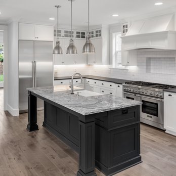Elite Tile Creations - a kitchen with white cabinets and a black island - Tiling Near Me Elite Tile Creations - a kitchen with white cabinets and a black island - Tiling Near Me