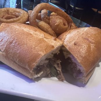 Jonathan's Grille - Philly Cheesesteak with onion rings - American Near Me - Mount Juliet, Tennessee Jonathan's Grille - Philly Cheesesteak with onion rings - American Near Me - Mount Juliet, Tennessee