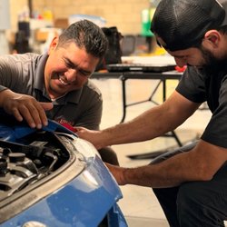 LUMA Auto Studio - Arturo working alongside another installer to fit PPF on this BMW. Explore paint protection options with LUMA Auto Studio, Riverside, CA.