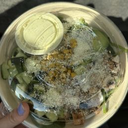 Rice bowl with various topping such as corn, cucumber,  avocado, cheese, and chicken