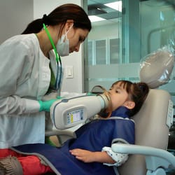 American Pediatric Dental Group - Doral - Getting X-rays done while watching Big Hero 6 on the TV Screen above