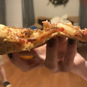 Mellow Mushroom Cary - a hand holding a half eaten pizza - Pizza Near Me - Cary, North Carolina Mellow Mushroom Cary - a hand holding a half eaten pizza - Pizza Near Me - Cary, North Carolina