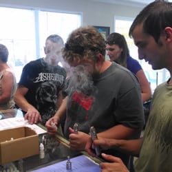Customer trying liquid at our one year anniversary party!