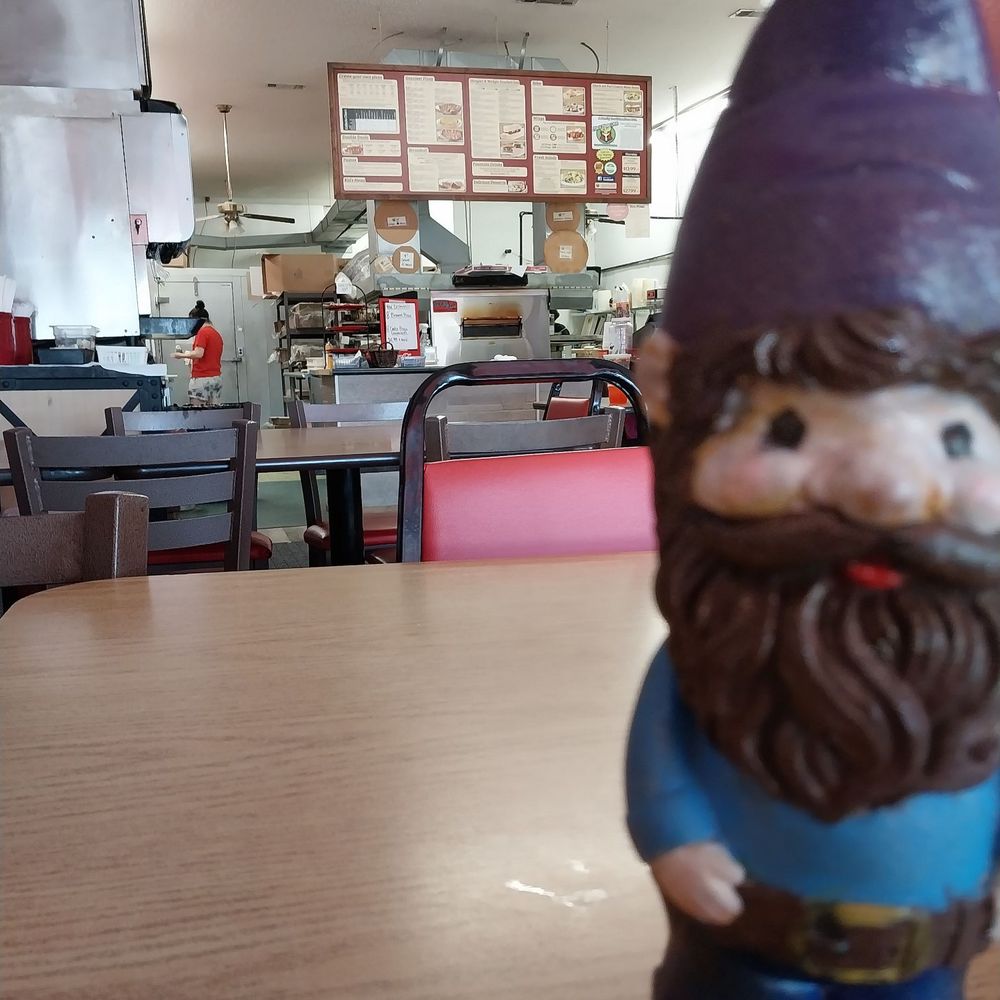 Fox's Pizza Den - a gnome figurine on a table - Pizza Near Me - Delhi, Louisiana Fox's Pizza Den - a gnome figurine on a table - Pizza Near Me - Delhi, Louisiana