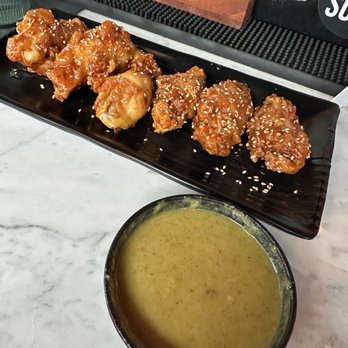DOMU - Signature crispy hot and Fresh Wings. With a side of their seasonal sauce which is curry - Ramen Near Me - Orlando, Florida