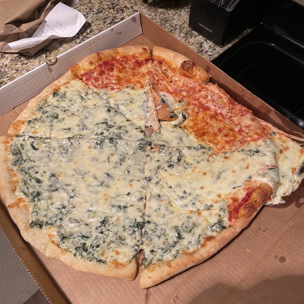 First pizza that came. Half plain, half white with spinach. First pizza that came. Half plain, half white with spinach.