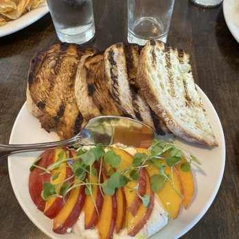 Bistro 23 - Burrata and grilled sourdough bread with jalapeño oil, fresh peaches, and micro greens. - New American Near Me - Portland, Oregon