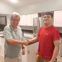 NTC Renovations - Here's a photo of Jose, our project manager with Dan, one of loyal customers! We had just repainted the cabinets you see behind them.