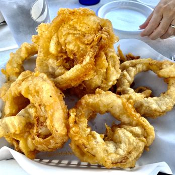 Dockside Dave's - The onion rings are fantastic! And, this is a SMALL. Notice the hand in the background for scale. It was huge! - Seafood Near Me - Madeira Beach, Florida Dockside Dave's - The onion rings are fantastic! And, this is a SMALL. Notice the hand in the background for scale. It was huge! - Seafood Near Me - Madeira Beach, Florida