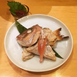 Snapper "O-Kashira", head and tail - "Sujiko", salmon roe next to it