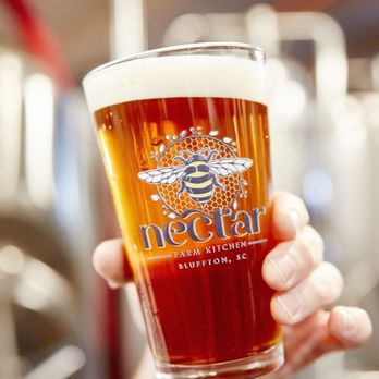Nectar Old Town Bluffton - a hand holding a glass of beer - Southern Near Me - Bluffton, South Carolina