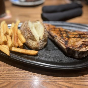 Outback Steakhouse - Bone Bone-In New York Strip* 16 oz. Plain baked potato Aussie Fries - Steakhouses Near Me - Clive, Iowa Outback Steakhouse - Bone Bone-In New York Strip* 16 oz. Plain baked potato Aussie Fries - Steakhouses Near Me - Clive, Iowa