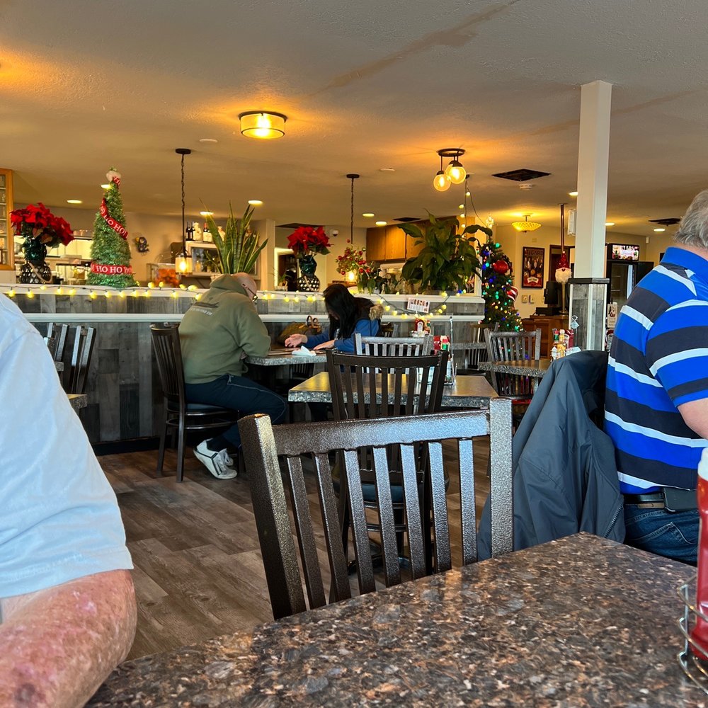 Davidson's - a man sitting at a table - American Near Me - Tigard, Oregon