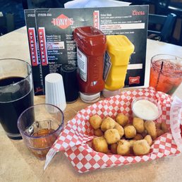 a tray of fried potatoes and a glass of soda a tray of fried potatoes and a glass of soda