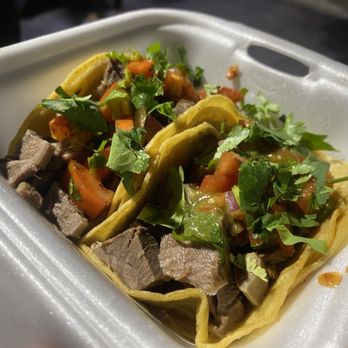 El Puente Taqueria - Lengua tacos finished with toppings from the salsa bar. - Food Trucks Near Me - Stockton, California El Puente Taqueria - Lengua tacos finished with toppings from the salsa bar. - Food Trucks Near Me - Stockton, California