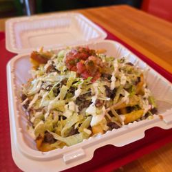 Asada Fríes, custom with extras like lettuce and extra sour cream