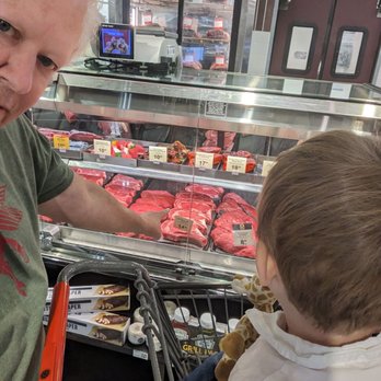 Market Street - Teaching "the Kid" finer points of purchasing meat - Grocery Near Me - McKinney, Texas