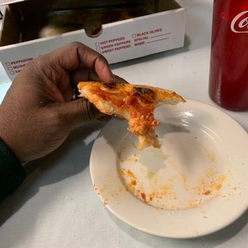 Moni's Pasta & Pizza - a hand holding a slice of pizza - Italian Near Me - Glenn Heights, Texas