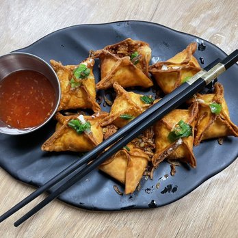 Mama Hue - a plate of dumplings with chopsticks and sauce - Vietnamese Near Me - Vero Beach, Florida