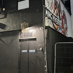 The Dead Canary - The entrance with empty bird cage hanging above it and doorbell on the right.