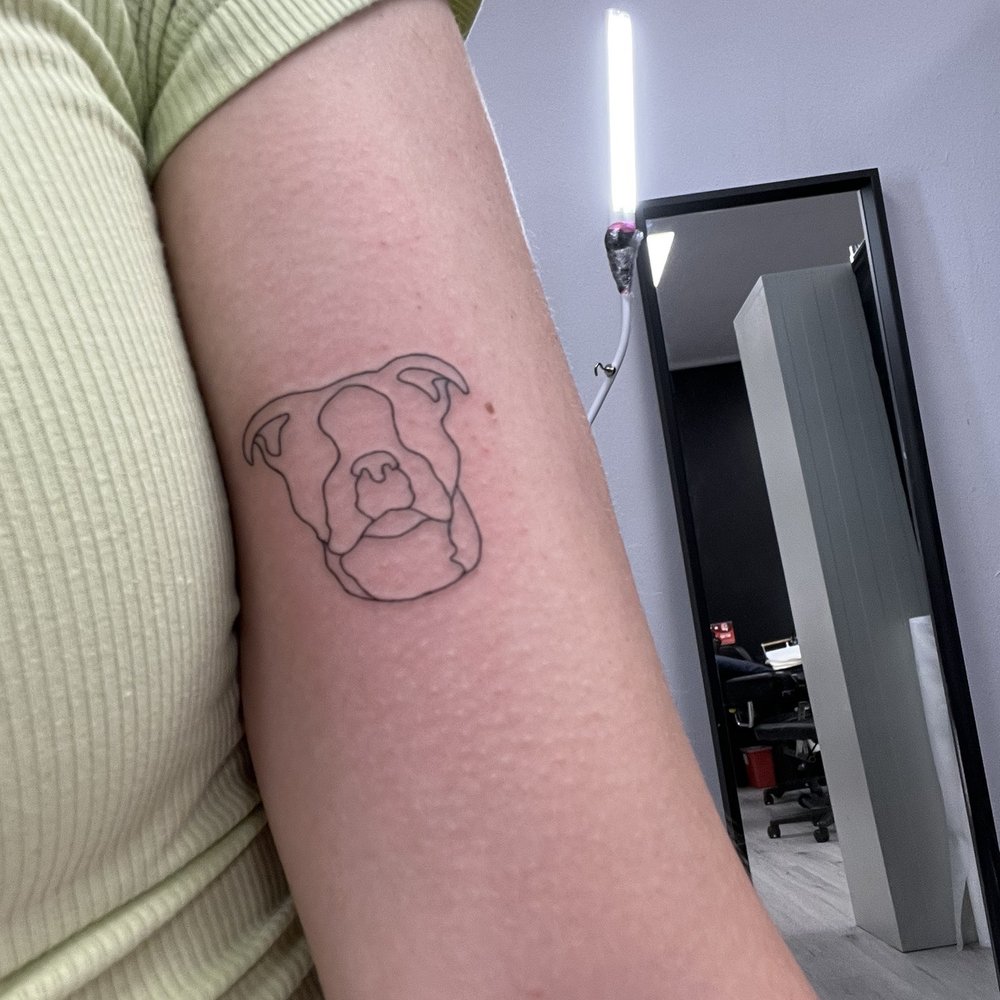 Gee Ink Tattoo - A close up picture of an arm where a new tattoo of an outline of a dog. - Tattoo Near Me - Alhambra, California Gee Ink Tattoo - A close up picture of an arm where a new tattoo of an outline of a dog. - Tattoo Near Me - Alhambra, California