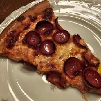 The Village Pizza and Pints - a slice of pizza on a plate - Pizza Near Me - Hamburg, New York The Village Pizza and Pints - a slice of pizza on a plate - Pizza Near Me - Hamburg, New York