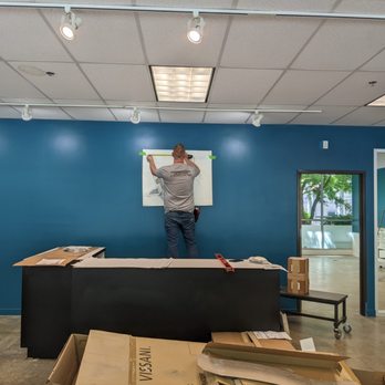 International Graphics And Nameplate - installing the logo behind the cashwrap - Graphic Design Near Me - Vancouver, Washington